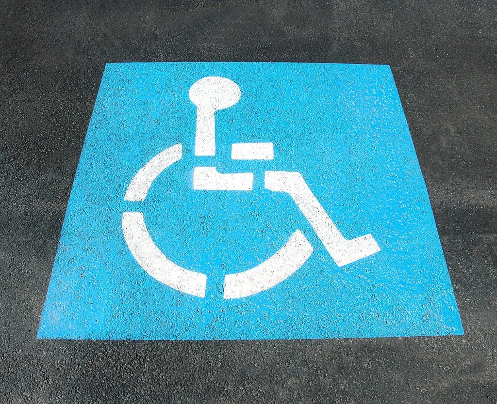 Blue handicap icon on a parking space